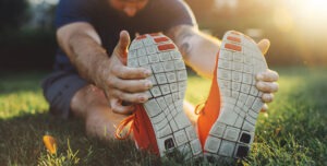 man performing seated hamstring stretch