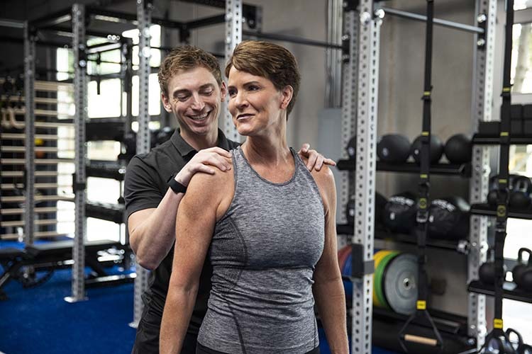 professional assisted stretching. Professional assesses shoulder mobility