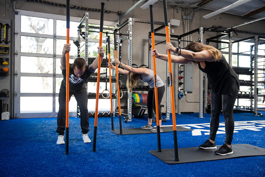 group stretching with stick mobility equipment