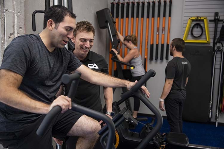 stretch professionals assist clients in workout