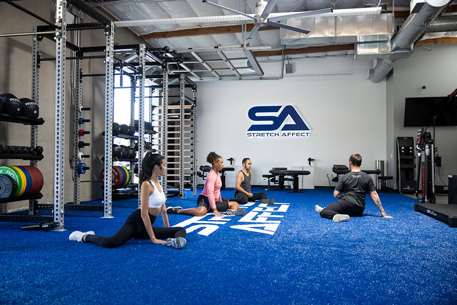 group stretching on the floor at Stretch Affect