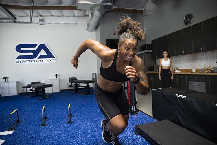 athletic client mid sprint in gym