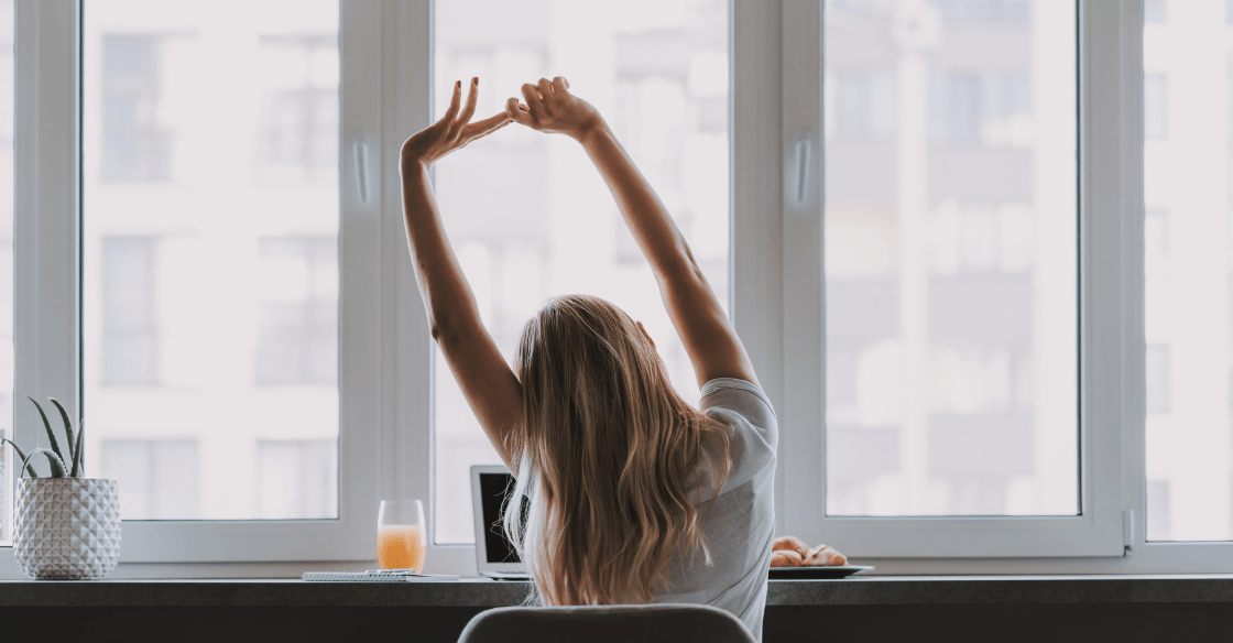 Woman performs stretching for office workers to combat the struggles of being a deskbound athlete.
